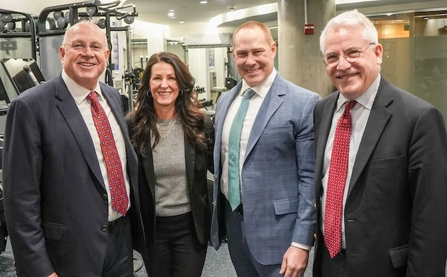 four people posing together for a photo