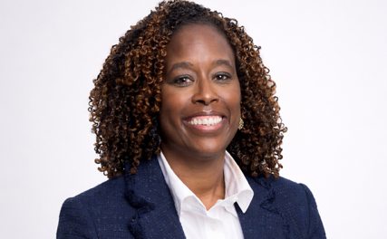 A professional headshot of a woman in a business suit.