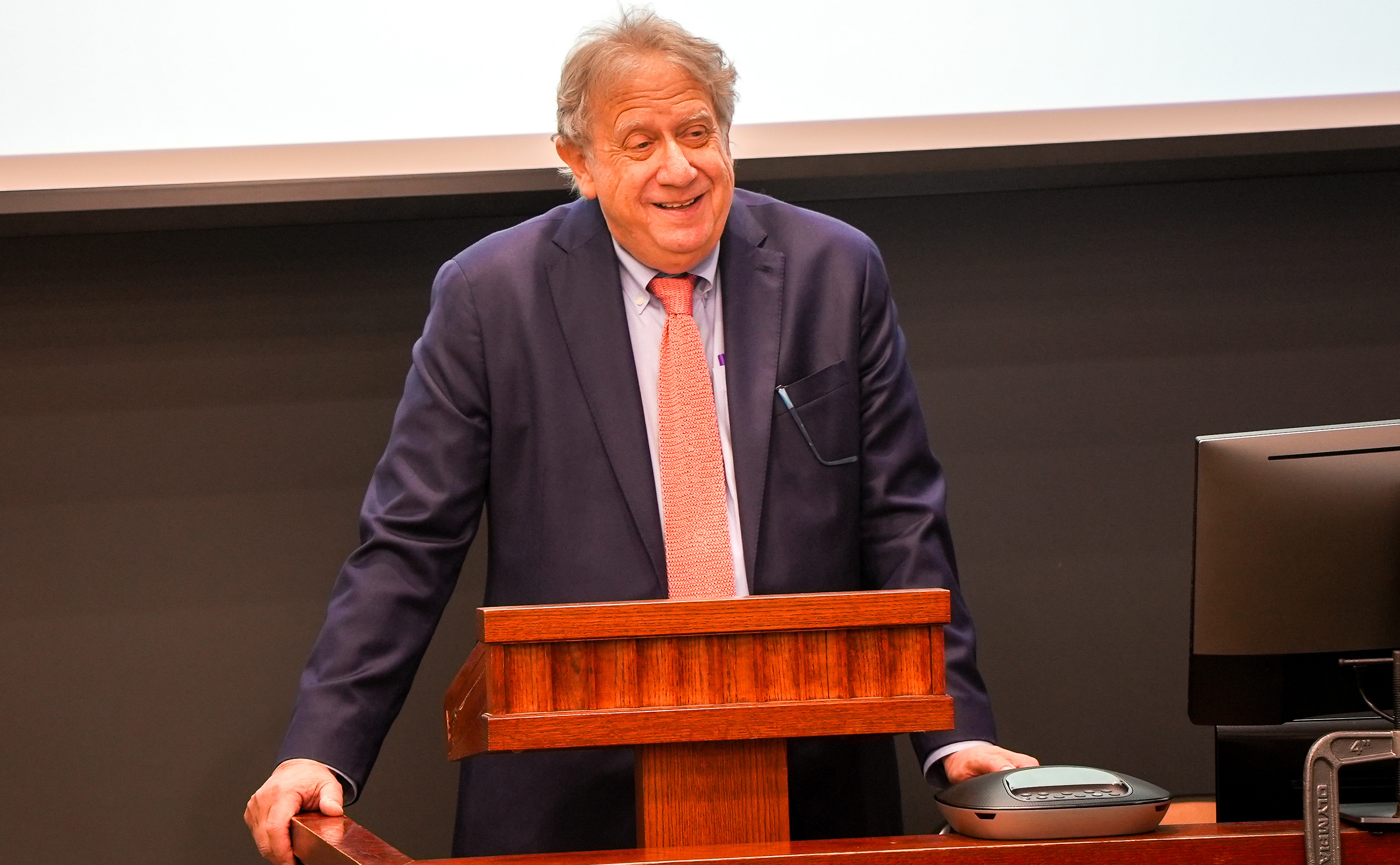 Brooklyn Law School Professor Michael Gerber smiles while speaking from behind a podium.