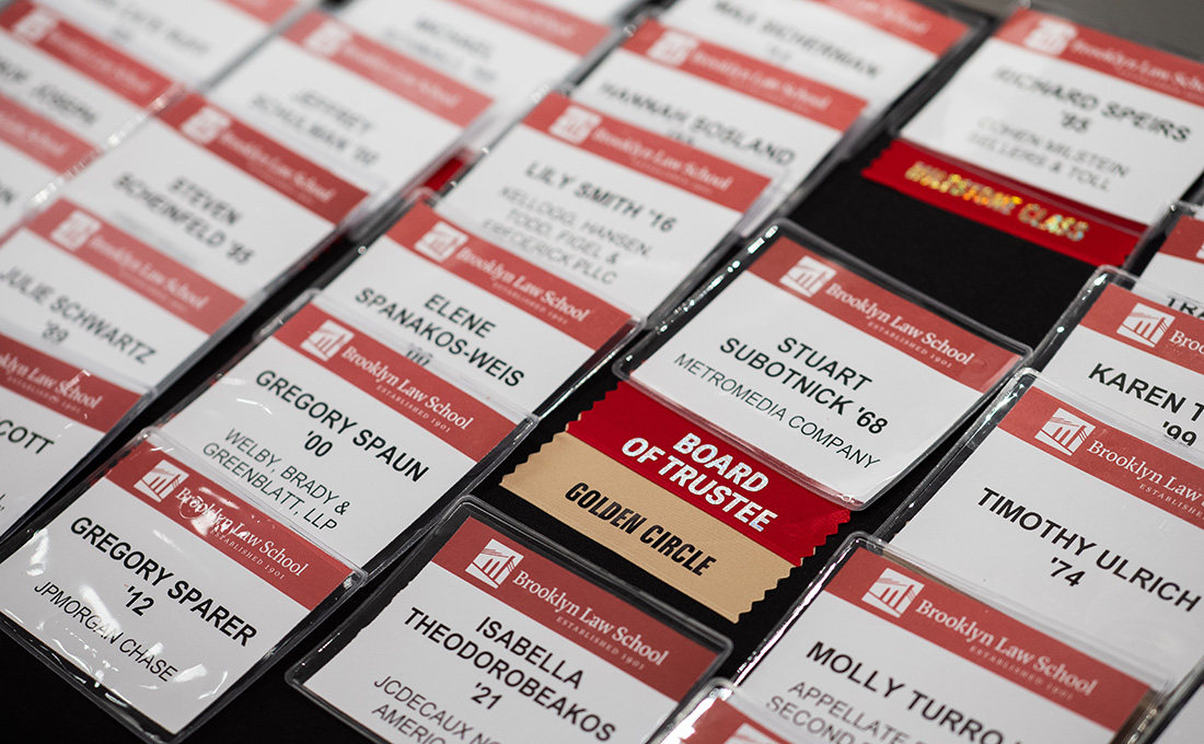 Assorted Brooklyn Law School name tags on a table.