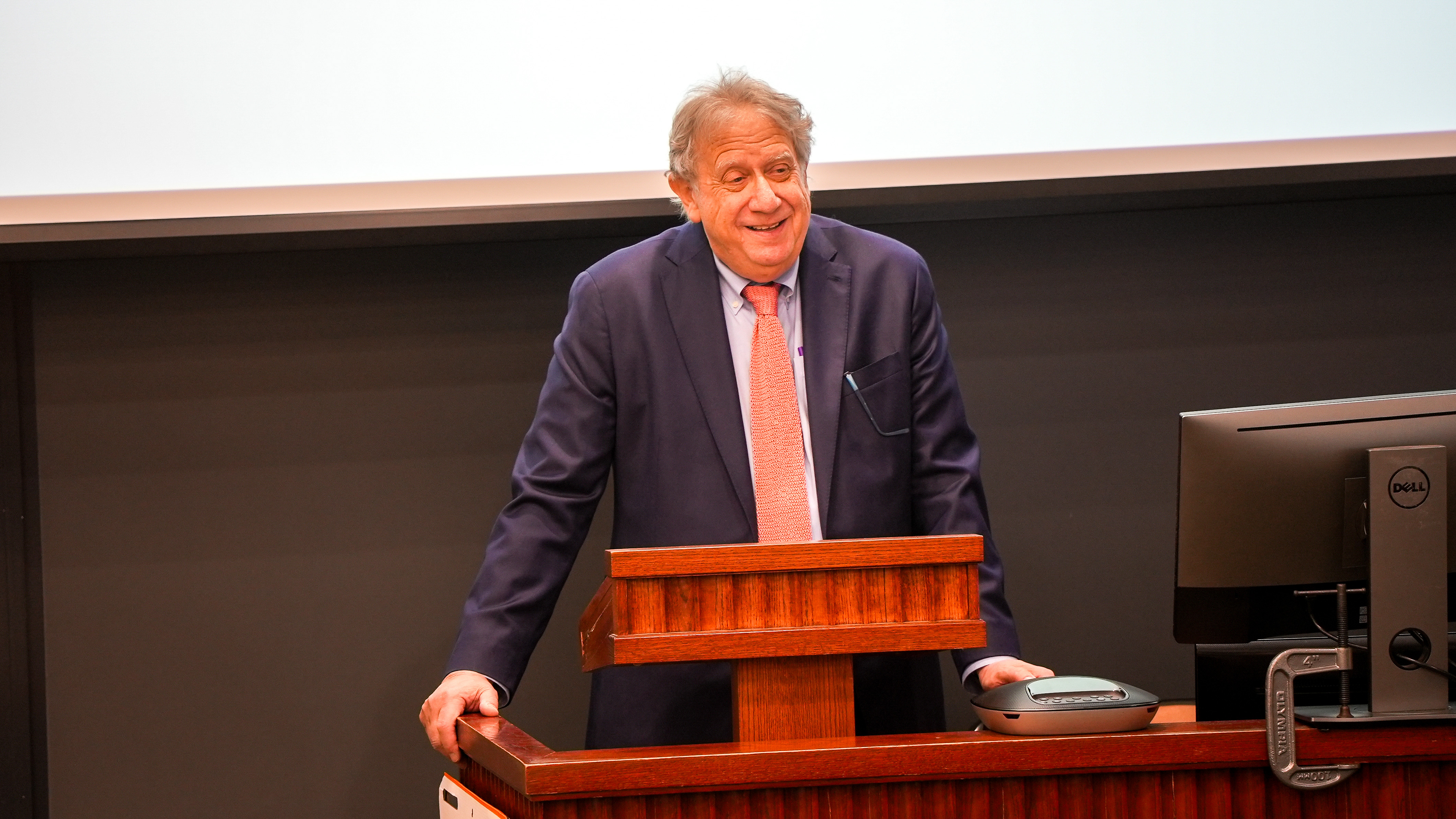 Brooklyn Law School Professor Michael Gerber smiles while speaking from behind a podium.