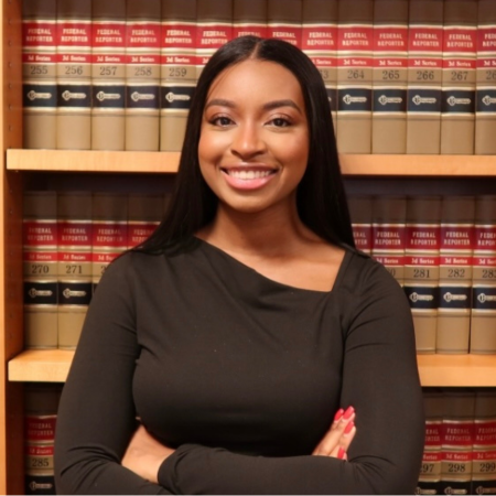 Janiera Headley_ student headshot in front of book shelf