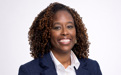 A professional headshot of a woman in a business suit.