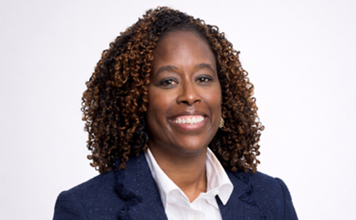 A professional headshot of a woman in a business suit.